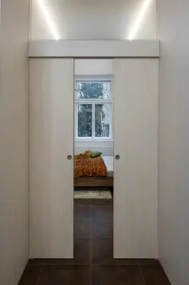 a living room with a green couch and a brick wall at Prague Days - Elegant Open-plan Apartment in Old Town in Prague