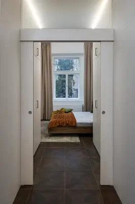 a living room with a green couch and a brick wall at Prague Days - Elegant Open-plan Apartment in Old Town in Prague