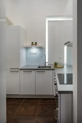 a dining room with white walls and a table and chairs at Prague Days - Elegant Open-plan Apartment in Old Town in Prague