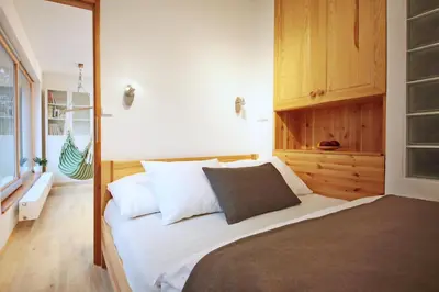a bedroom with a large bed with white pillows at Invalidovna Apartment in Prague