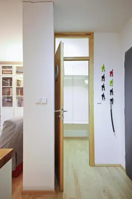 an open door in a room with a bedroom at Invalidovna Apartment in Prague
