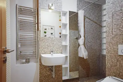 a bathroom with a sink and a toilet at Invalidovna Apartment in Prague