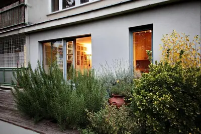 a house with plants in front of a window at Invalidovna Apartment in Prague