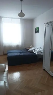 a bedroom with a bed and a window at Apartmán Malvazinky in Prague