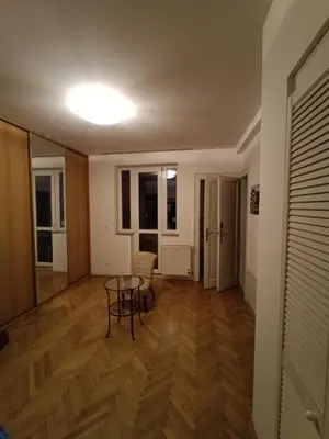 a living room with a table and chairs at Apartmán Malvazinky in Prague