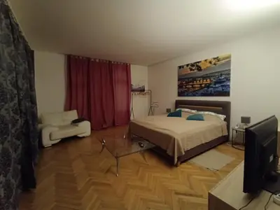 a bedroom with a bed and a tv in it at Apartmán Malvazinky in Prague