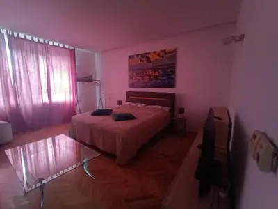 a bedroom with a bed and a glass table at Apartmán Malvazinky in Prague