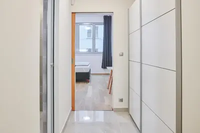 a hallway with a door leading to a bedroom at Apartments Harfa in Prague