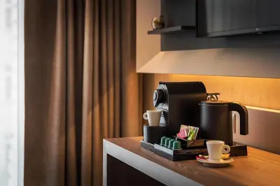 a coffee maker and cups on a counter in a hotel room at Hotel CUBE Prague in Prague