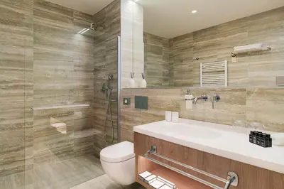 a bathroom with a toilet and a sink and a shower at Hotel CUBE Prague in Prague
