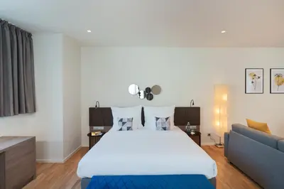 a bedroom with a large bed and a couch at Hotel CUBE Prague in Prague