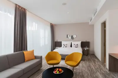 a hotel room with a bed and a couch at Hotel CUBE Prague in Prague