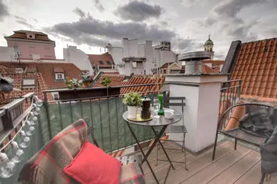 a balcony with a table and chairs on a roof at Charming APT Old Town Prague by Michal&Friends in Prague