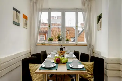 a dining room with a table and chairs and a window at Charming APT Old Town Prague by Michal&Friends in Prague