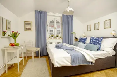 a bedroom with a large bed with blue and white pillows at Charming APT Old Town Prague by Michal&Friends in Prague