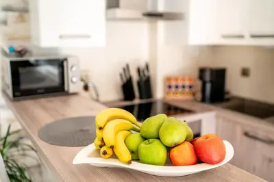 a plate of fruit on a counter in a kitchen at Apartmán u Jiříka in Poděbrady