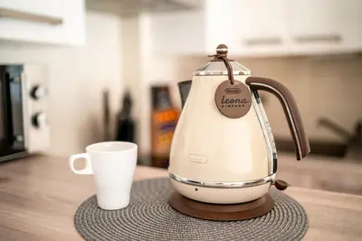 a coffee maker sitting next to a cup on a counter at Apartmán u Jiříka in Poděbrady