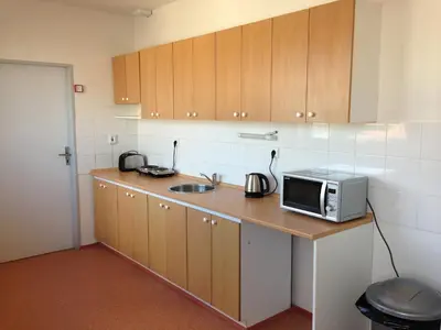 a kitchen with a sink and a microwave on a counter at Hostel BOHEMIA in Prague