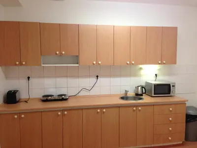 a kitchen with a microwave and a sink at Hostel BOHEMIA in Prague