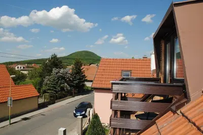 a balcony of a house with a car on a street at Chalet Lucie in Mnetěš