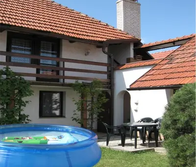 a house with a large blue barrel in the yard at Chalet Lucie in Mnetěš