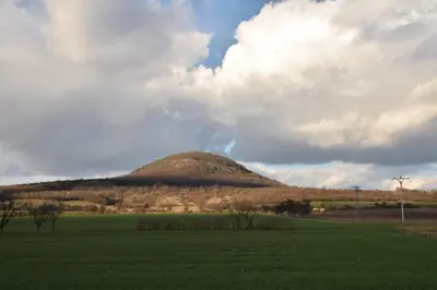 a hill in the middle of a green field at Chalet Lucie in Mnetěš