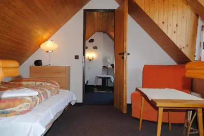 a room with two beds and a table in a room at Chalet Lucie in Mnetěš