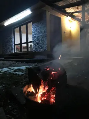 a fire in a pot in front of a building at Sazava River Cottage with boating experience in Týnec nad Sázavou