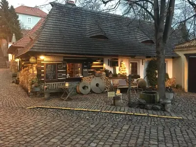 a small house with a roof on a brick street at Romantik Hotel U Raka in Prague