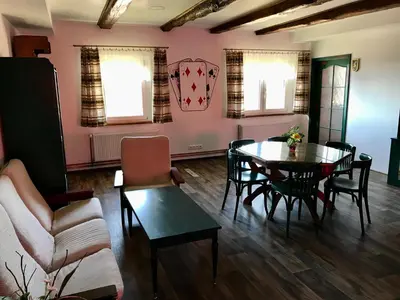 a large dining room with wooden tables and chairs at Bendovský dvůr in Dušníky