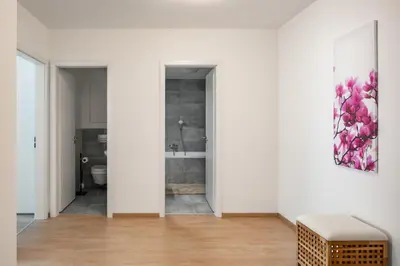 a white room with a bathroom with a sink at Prague Days - Apartment with Balcony and Parking in Trendy New Residential Area in Karlín in Prague