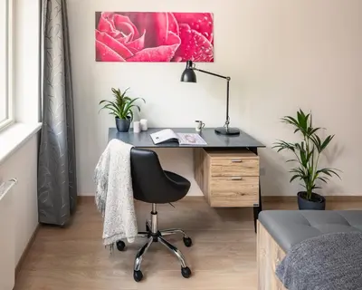 a bedroom with a desk with a chair and a bed at Prague Days - Apartment with Balcony and Parking in Trendy New Residential Area in Karlín in Prague