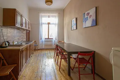 a kitchen with a table and chairs in a room at For celebrations spacious 3BDR apartment with balcony in Prague