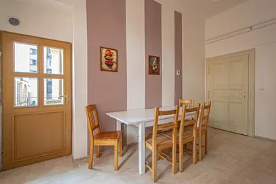 a dining room with a white table and chairs at For celebrations spacious 3BDR apartment with balcony in Prague