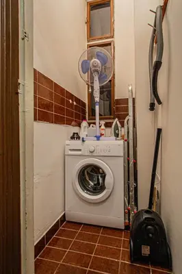 a washing machine with a fan in a room at For celebrations spacious 3BDR apartment with balcony in Prague