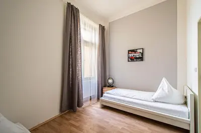 a bedroom with a bed and a window at For celebrations spacious 3BDR apartment with balcony in Prague