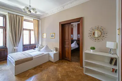 a bedroom with a bed and a mirror at For celebrations spacious 3BDR apartment with balcony in Prague