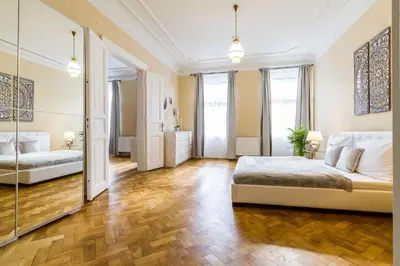a large bedroom with two beds and a mirror at Lovely 2BDs apartment near Petřín Tower - P14 in Prague
