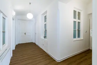 an empty hallway with white walls and windows at Lovely 2BDs apartment near Petřín Tower - P14 in Prague