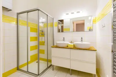 a bathroom with two sinks and a shower at Lovely 2BDs apartment near Petřín Tower - P14 in Prague