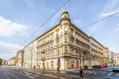 a large building with a clock tower on a street at Lovely 2BDs apartment near Petřín Tower - P14 in Prague