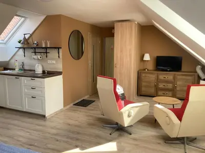 a kitchen with two chairs and a table and a sink at Pension Kotva in Beroun
