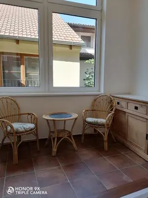 two chairs and a table in a room with a window at Pension Kotva in Beroun