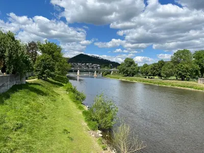 a view of a river with a bridge in the background at Pension Kotva in Beroun
