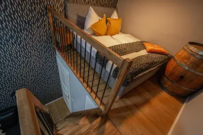 a bedroom with a bunk bed in a room with a barrel at Main train station apartment close to the the Main Square! in Prague
