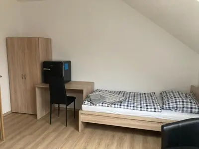 a bedroom with a bed and a desk with a television at Ubytování Na špejcharu, Želevčice in Slaný