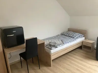 a small bedroom with a bed and a television at Ubytování Na špejcharu, Želevčice in Slaný