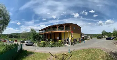 a large building with a balcony on a street at Vyhlídka Slapy Nová Živohošť in Křečovice