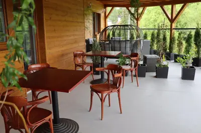 a patio with tables and chairs and potted plants at Vyhlídka Slapy Nová Živohošť in Křečovice