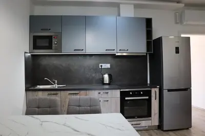 a kitchen with a stainless steel refrigerator and cabinets at Vyhlídka Slapy Nová Živohošť in Křečovice